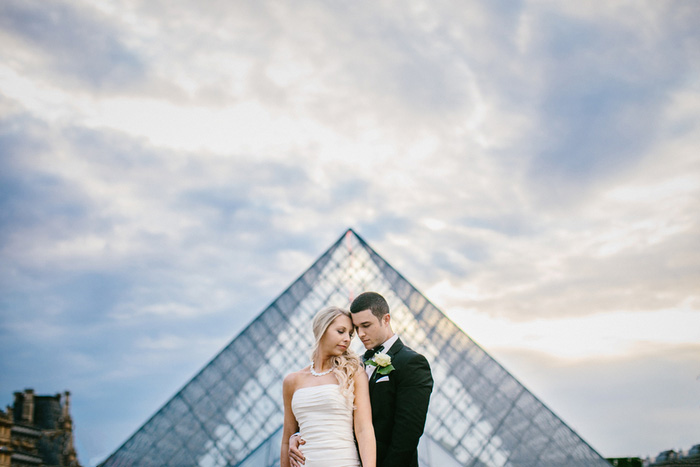 bride and groom in front of louvre