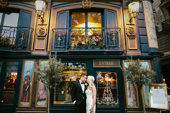 bride and groom in front of Paris Restaurant