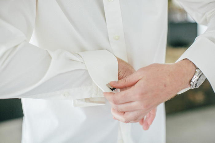 groom doing up cuffs