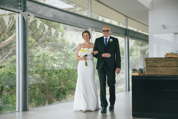 bride walking down aisle with her father