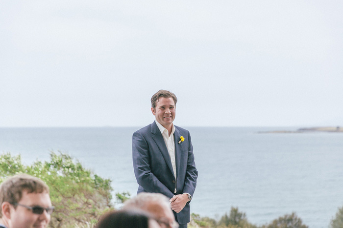 groom watching bride walk down aisle