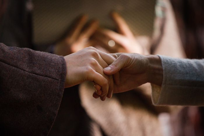 brides holding hands during ceremony