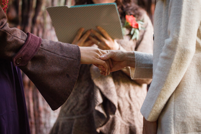 brides holding hands during ceremony