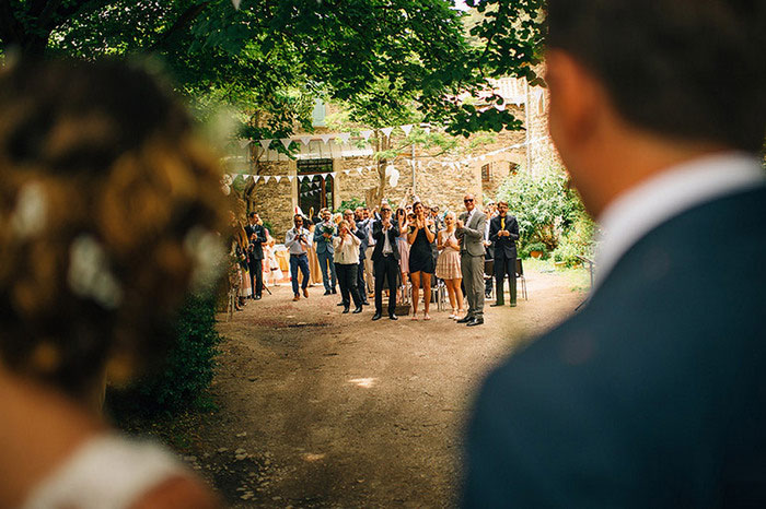 wedding guests cheering bride and groom