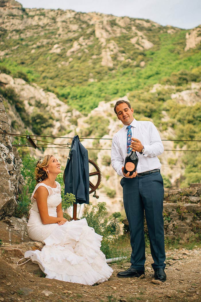 groom popping bottle of champagne