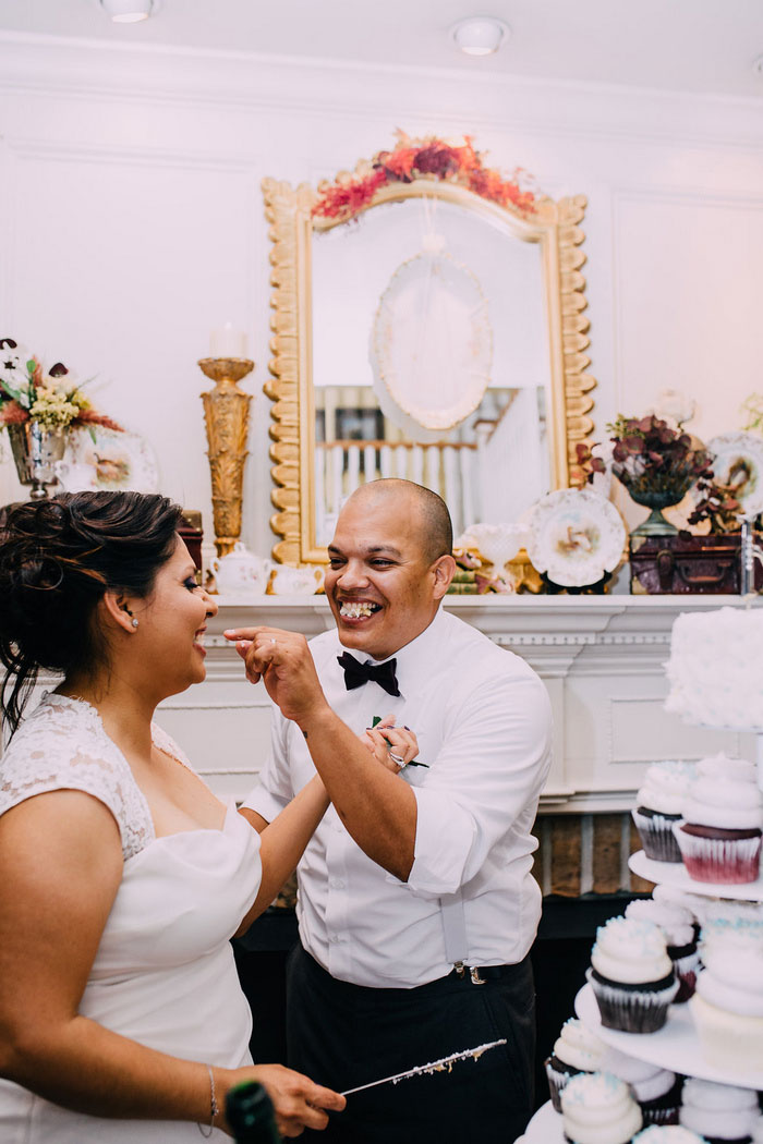 bride and groom feeding each other cake