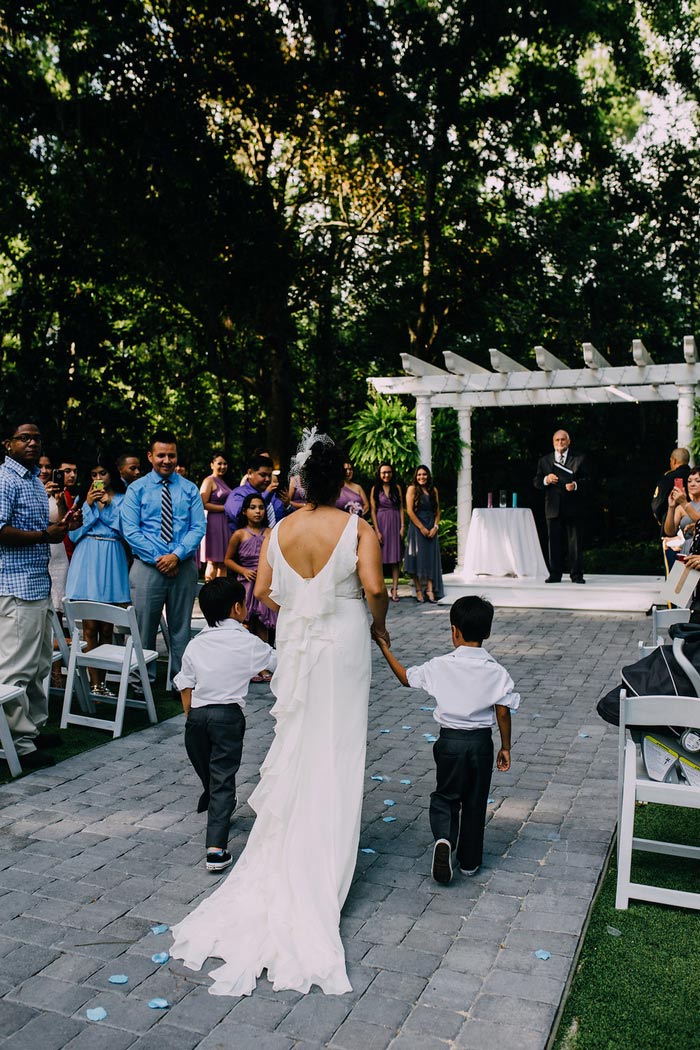 bride walking down aisle with sons