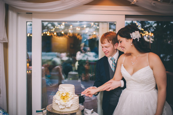 bride and groom cutting cake