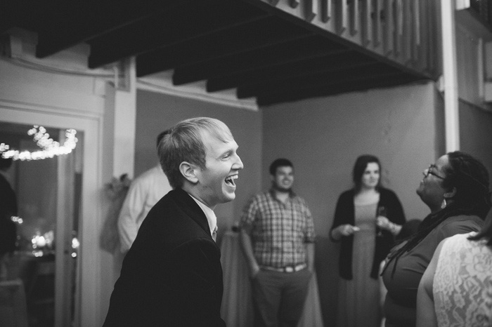 groom laughing at reception