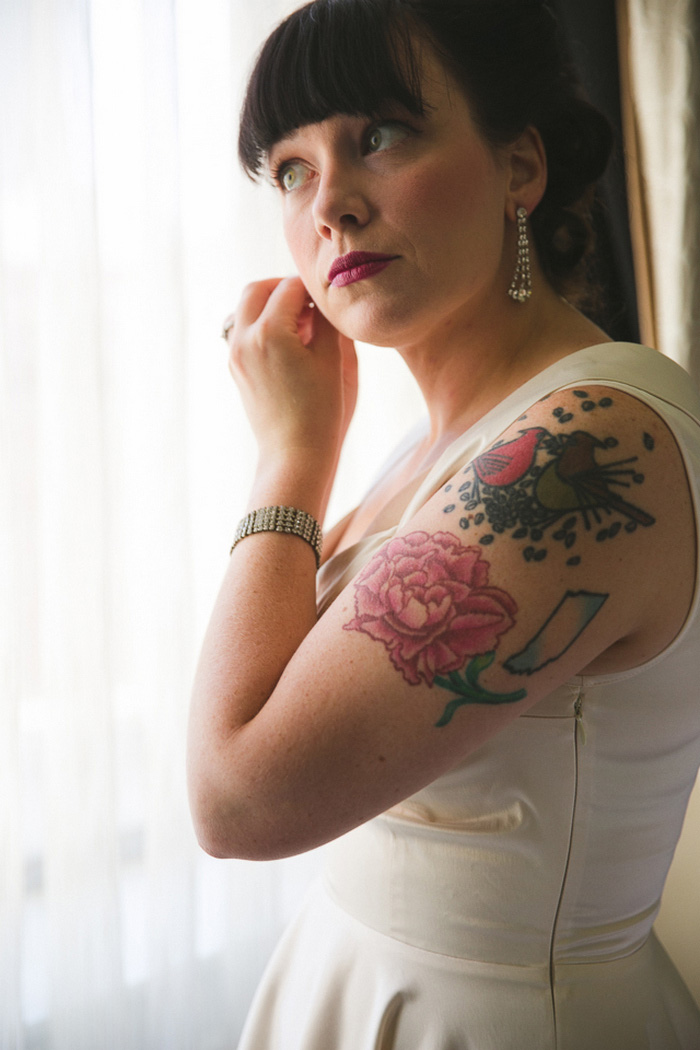 bride putting earrings on