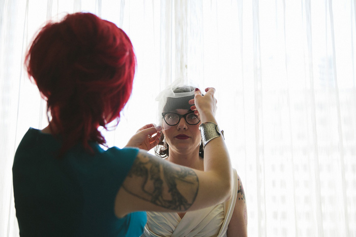 bride having her veil put on