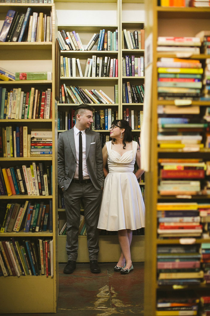 bride and groom portrait in bookstore