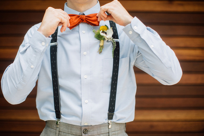 groom adjusting bow tie