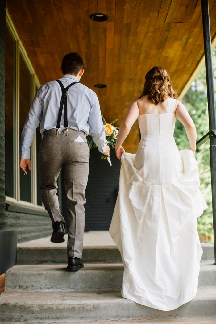 bride and groom climbing stairs