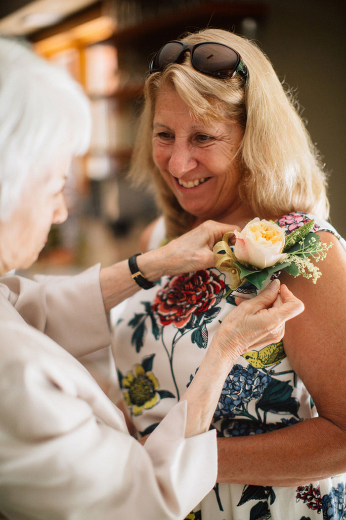 boutonniere being pinned on mother