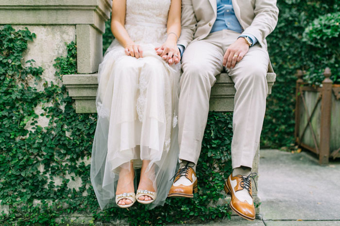 bride and groom sitting on stone step