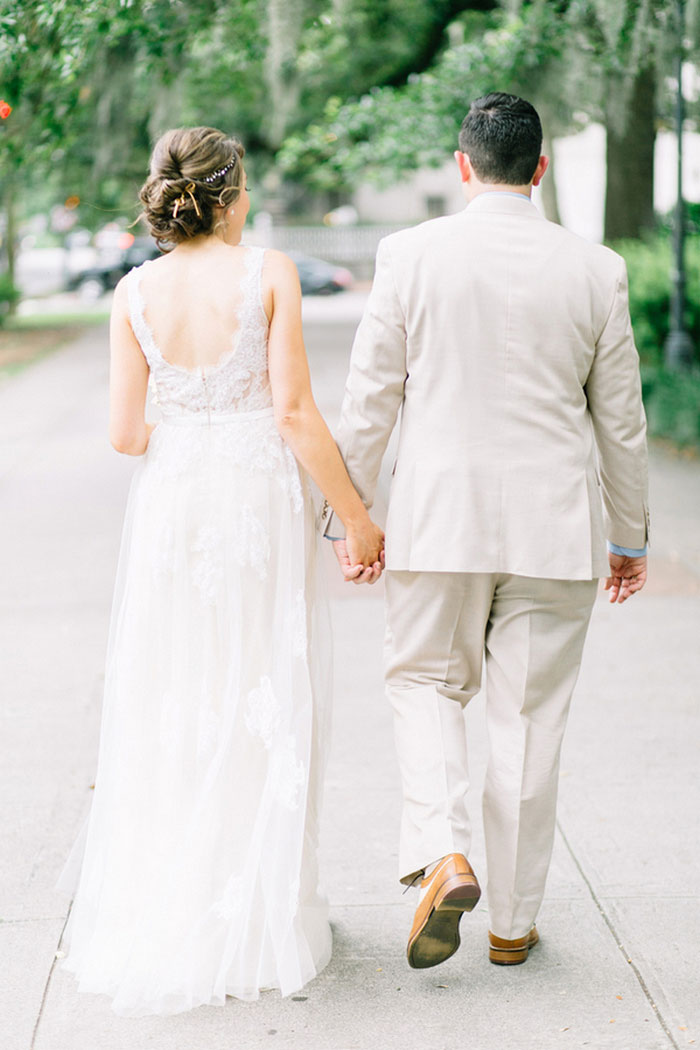 Bride and groom walking down Savannah street