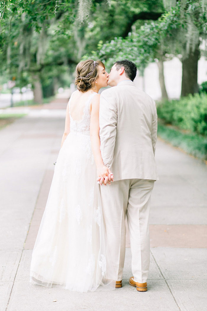 bride and groom kissing on Savannah street