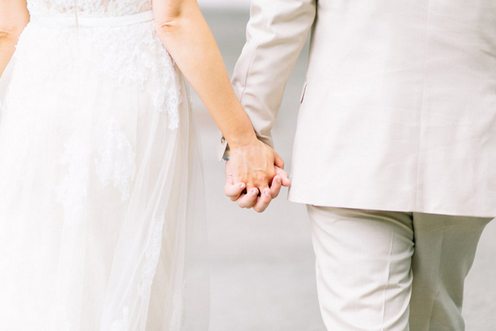 brid and groom holding hands