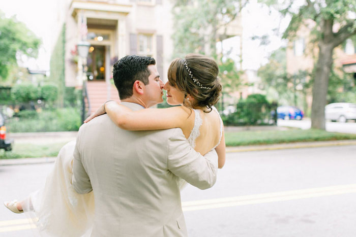 groom carrying bride