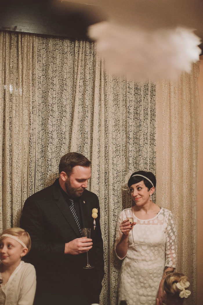 bride and groom eating cupcakes