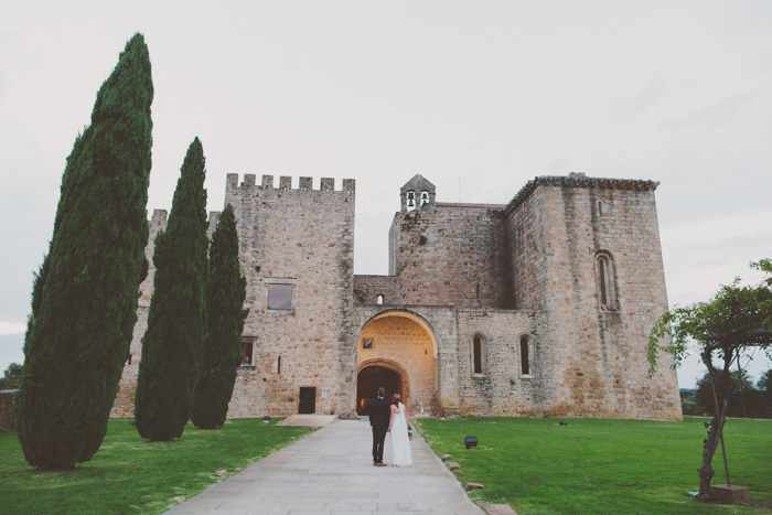 bride and groom entering castle