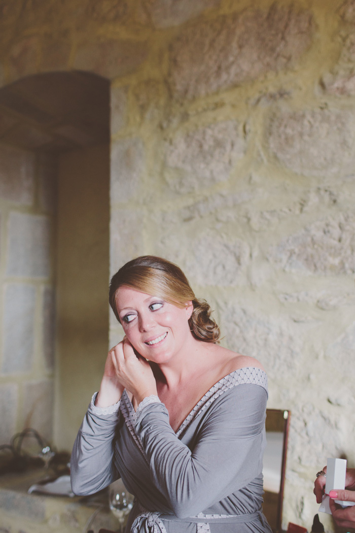 bride putting on earrings