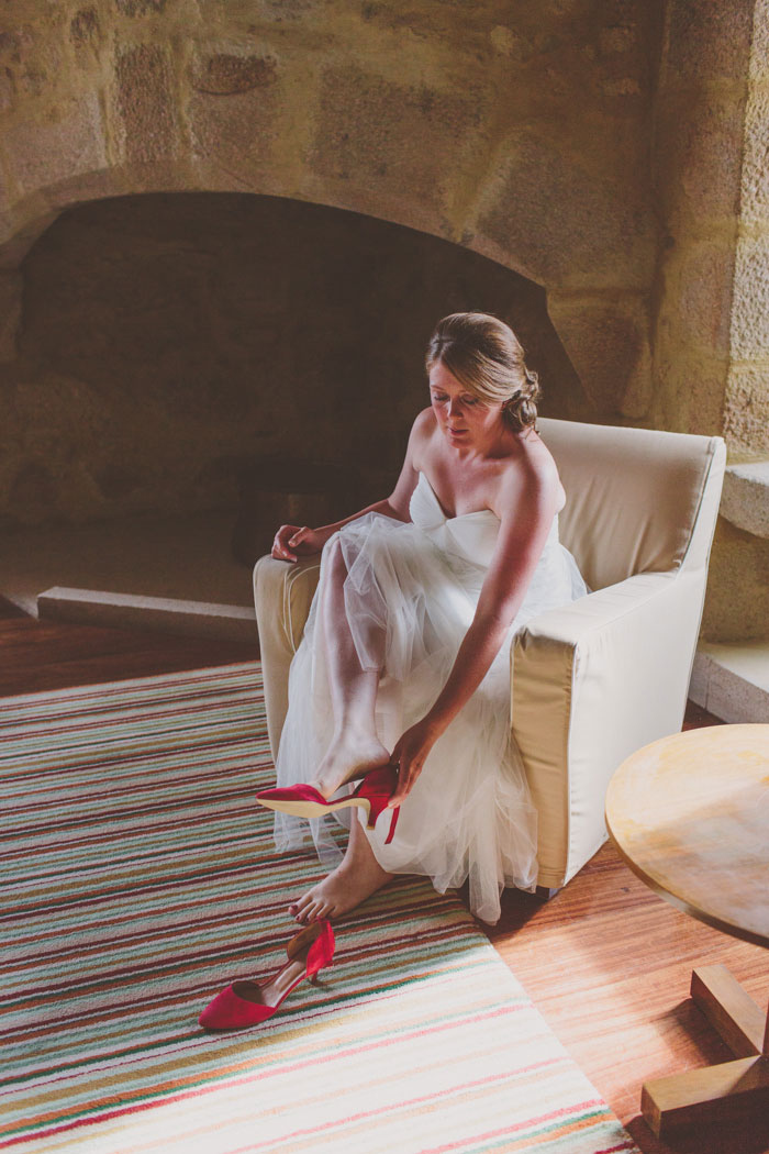 bride putting her shoes on