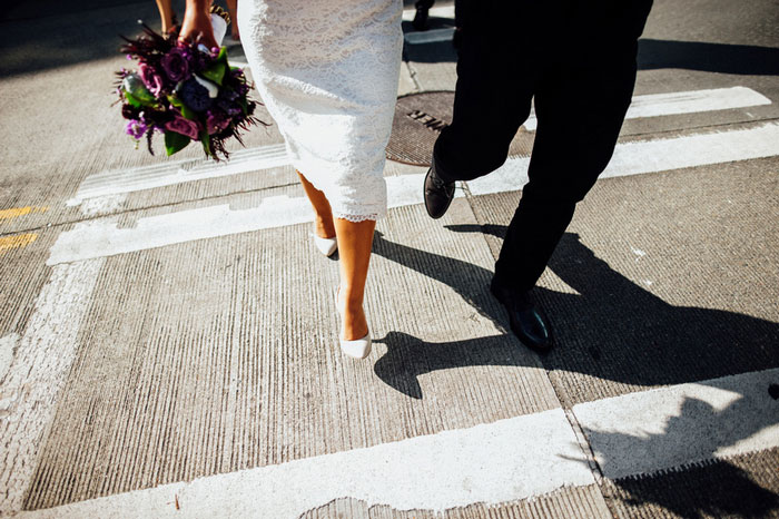 bride and groom crossing the street in Seattle