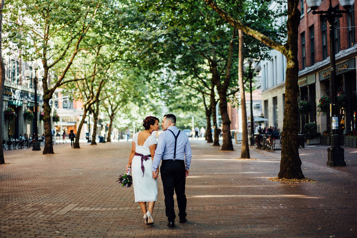 bride and groom walking down seattle street