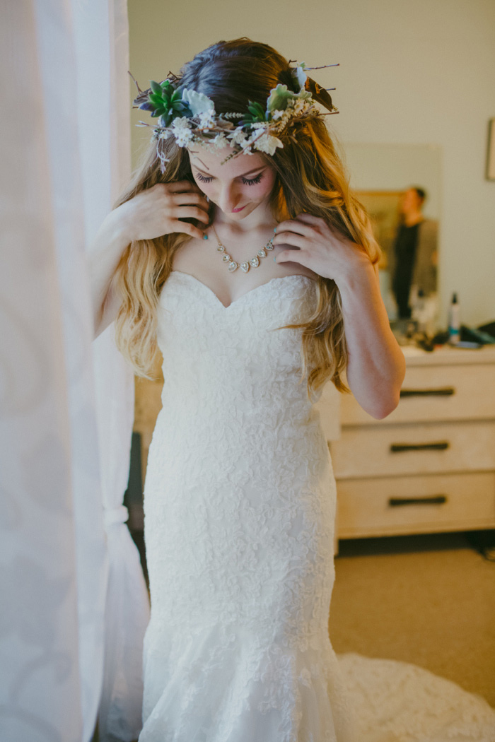 bride adjusting necklace