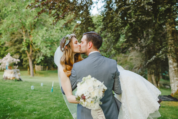 groom carrying bride and kissing her