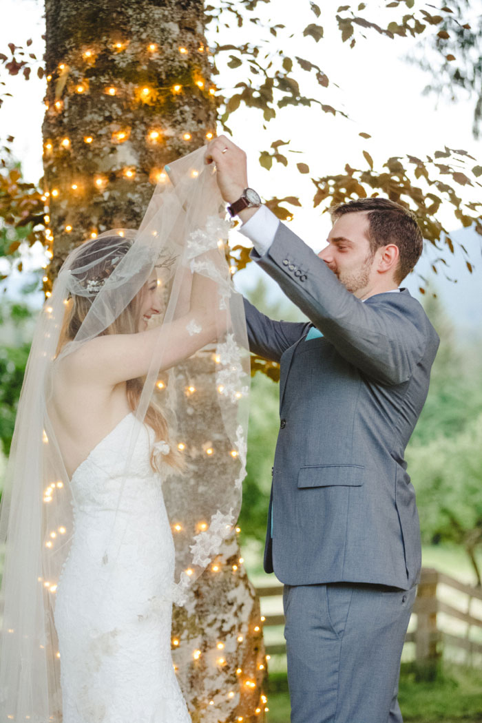 groom lifting bride's veil