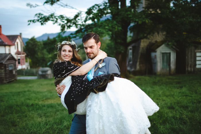 groom carrying bride