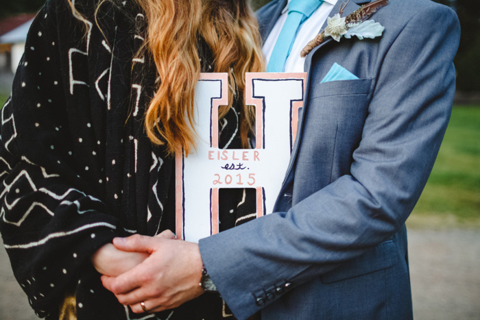 bride and groom holding letter h