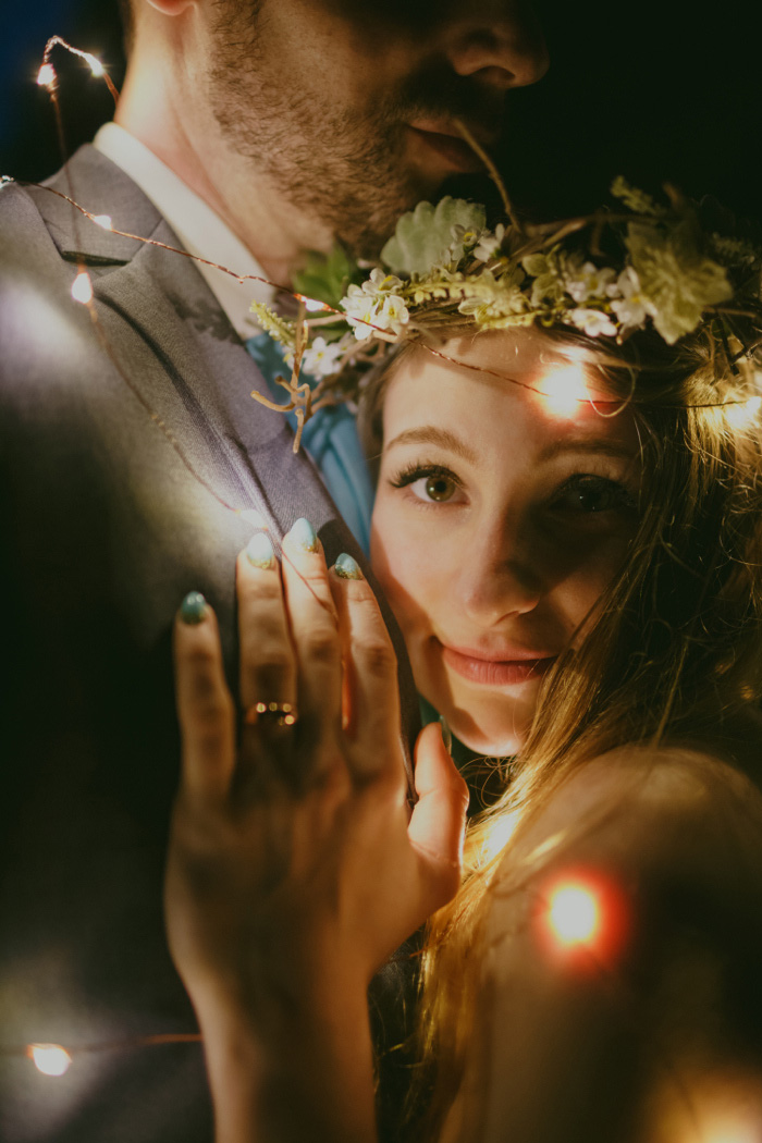 bride and groom wrapped in lights