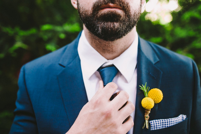 groom adjusting tie