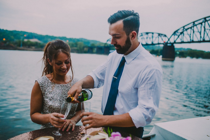 groom pouring champagne