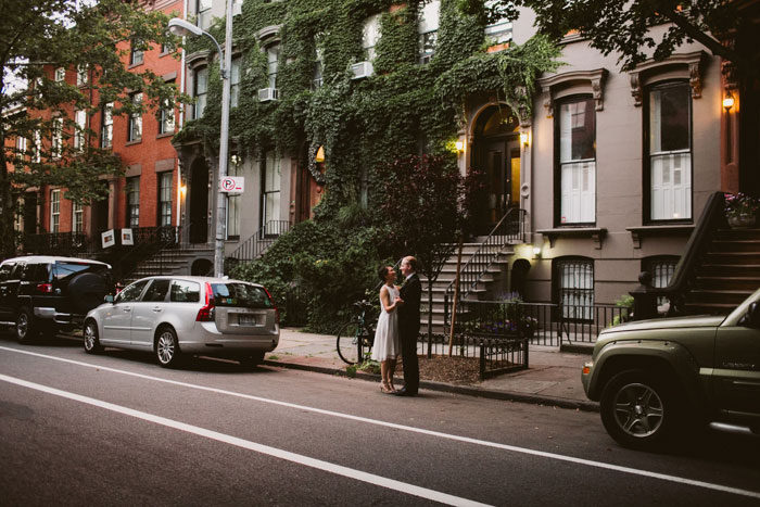 Bride and groom dancing in the street