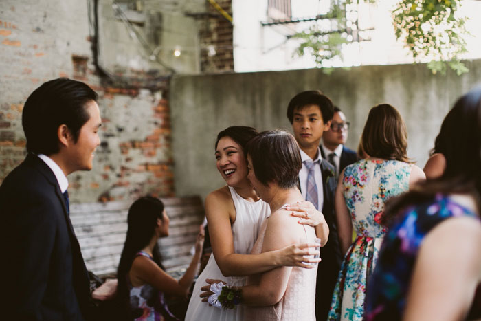 bride hugging her mom at reception