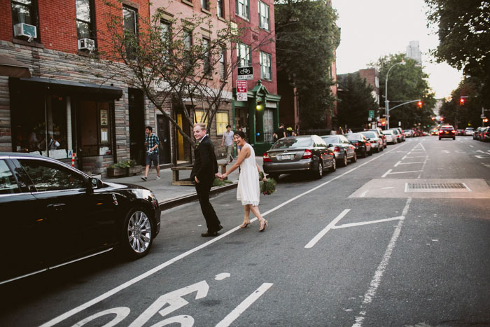 bride and groom crossing the street