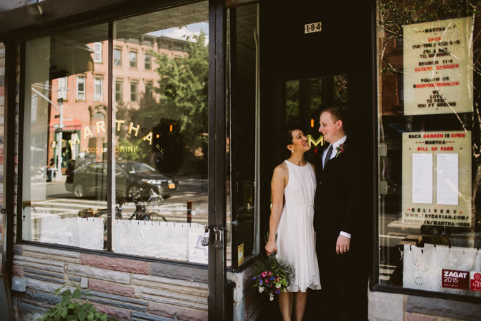 bride and groom in doorway of restaurant