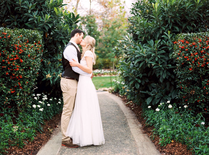 bride and groom kissing in garden