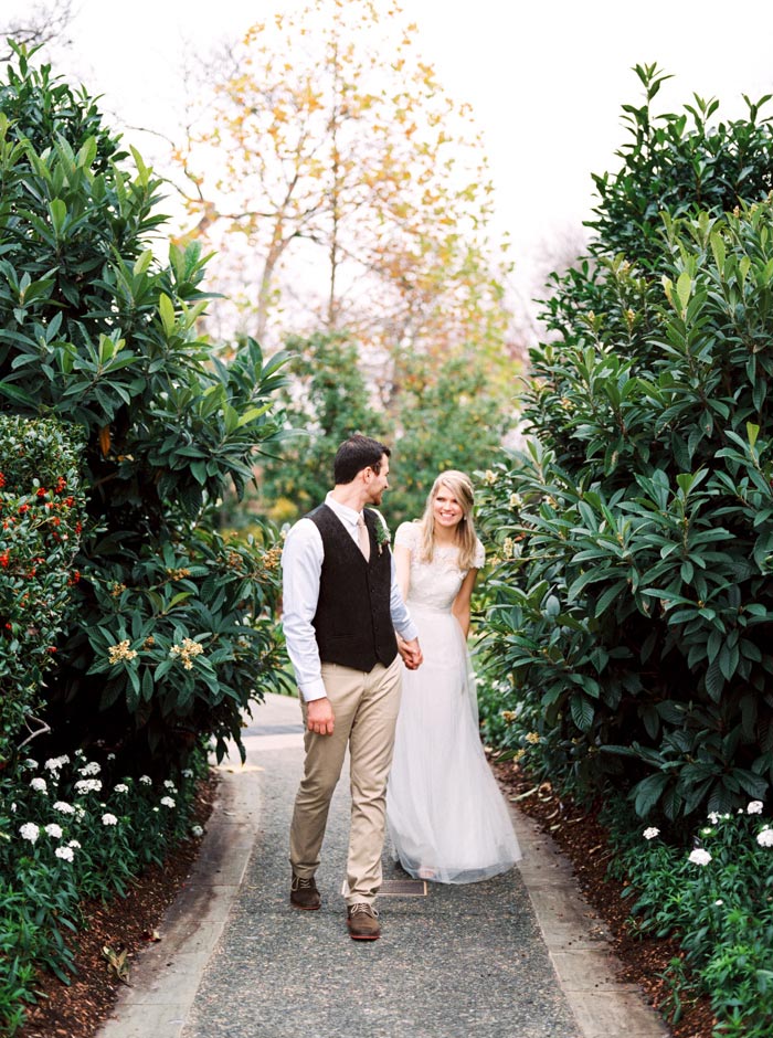 bride and groom walking down garden path