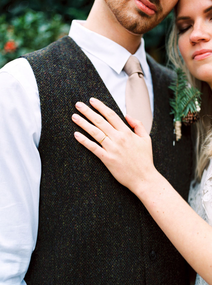 close-up of bride's hand on groom's chest