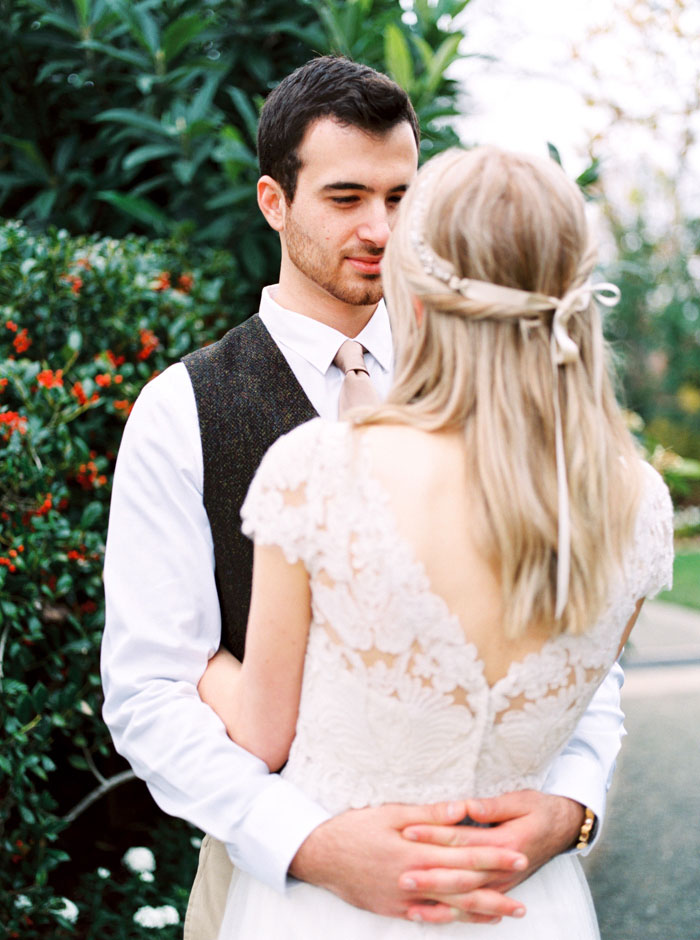 groom embracing bride