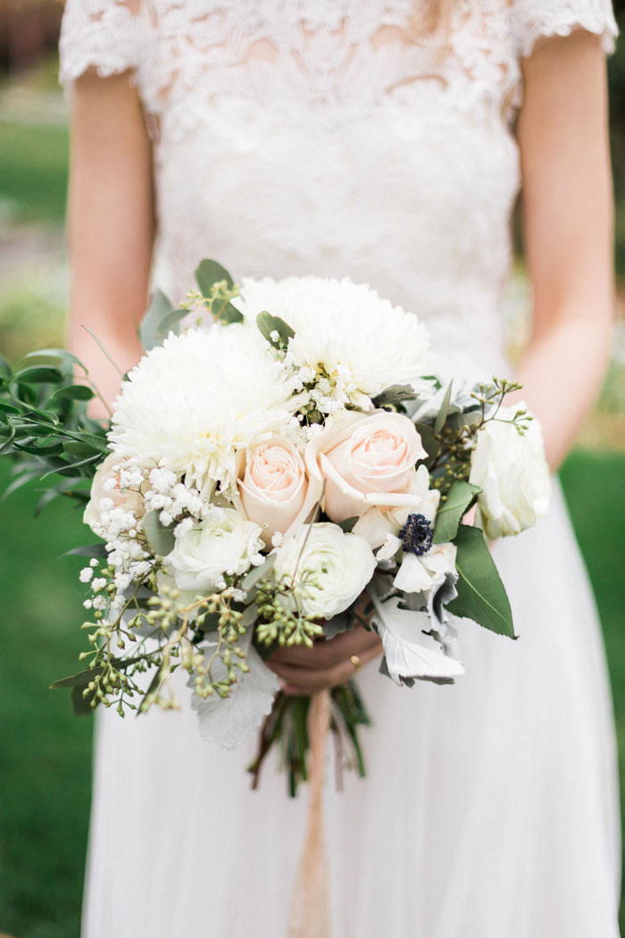 bride holding white and pink wedding bouquet