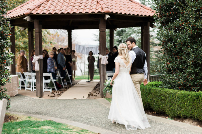 bride and groom walking to ceremony gazebo