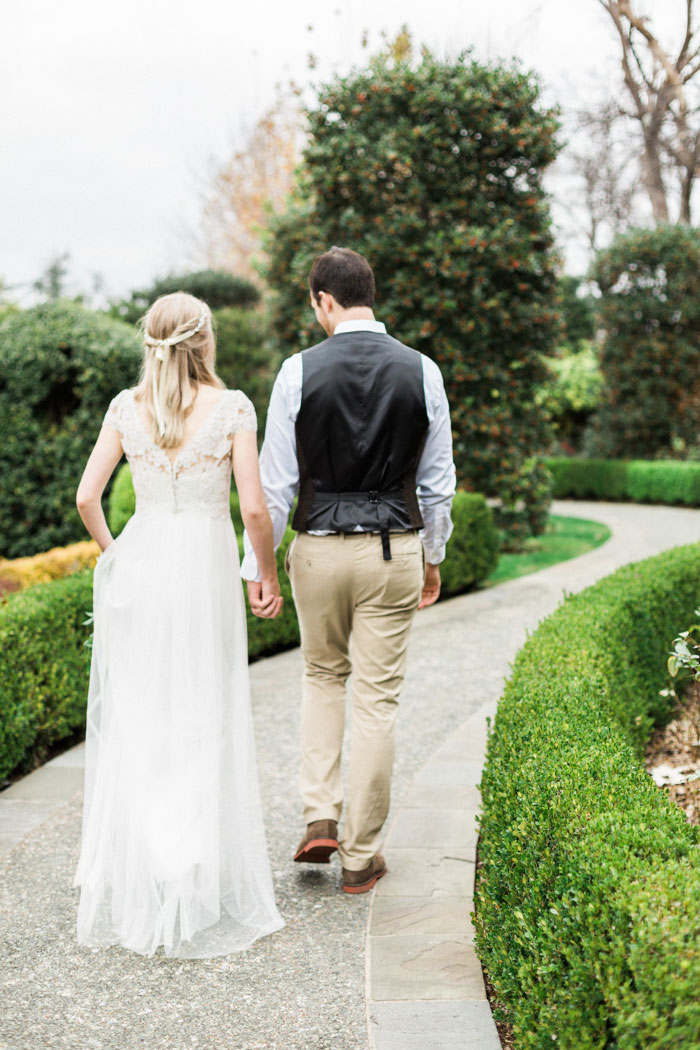 bride and groom walking down path