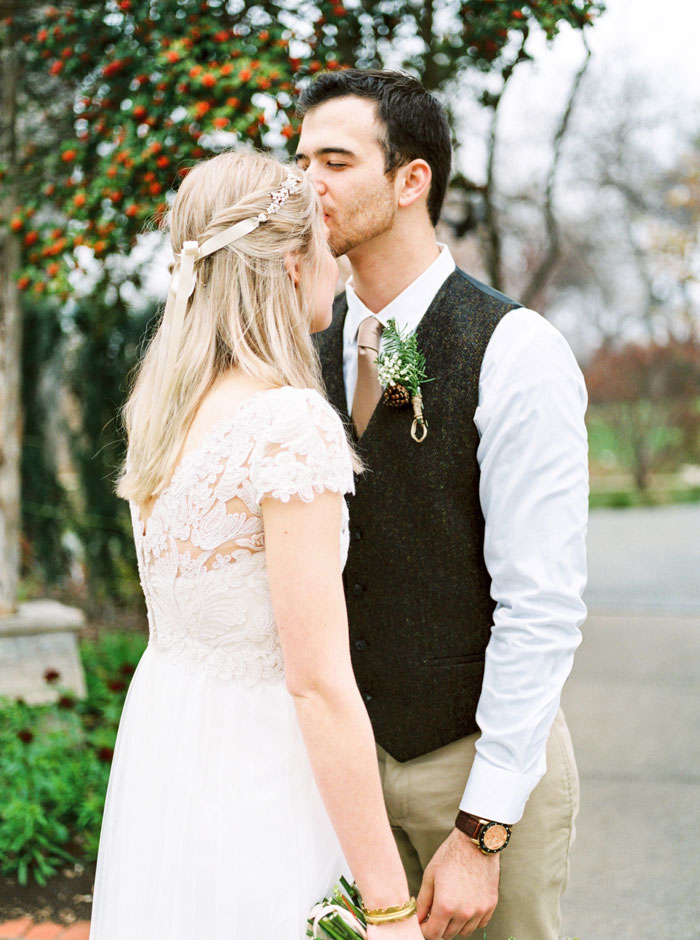 groom kissing bride on forehead